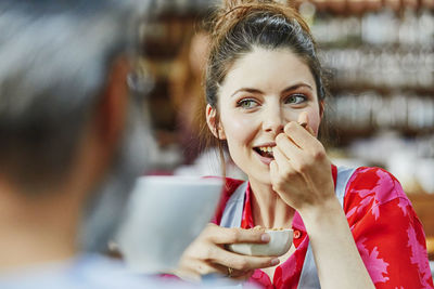 Portrait of smiling young woman using smart phone