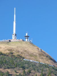 Low angle view of lighthouse against clear blue sky