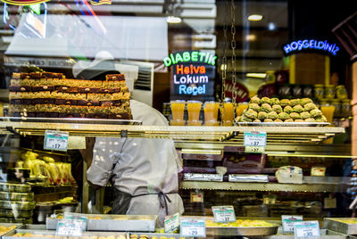 Close-up of foods for sale through the window of a sweet shop 