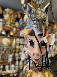 Close-up of  wolf  mask and of pig mask 