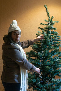 Side view of woman with christmas tree