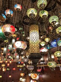 Low angle view of illuminated lanterns hanging in ceiling