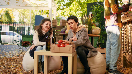 Portrait of friends sitting on table