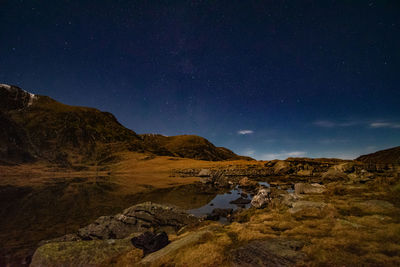 Scenic view of mountains against sky at night