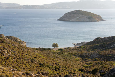 Scenic view of sea and mountains against sky