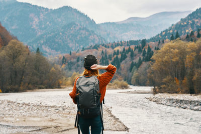 Rear view of man standing on mountain road