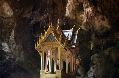 Low angle view of temple against rock formation