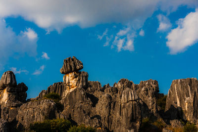 Low angle view of rock formations against sky