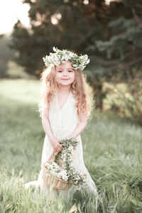 Portrait of cute girl wearing wreath at park