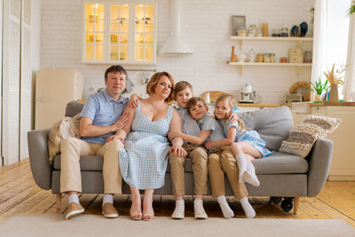 Christian big family. large family at home on sofa in living room. family