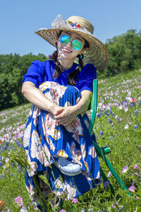 Woman wearing hat while standing on field