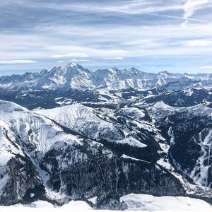 Scenic view of snow covered mountains against sky