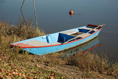 Boat moored on lake shore