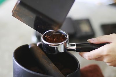 Close-up of hand holding coffee cup