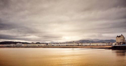 Scenic view of sea by city against sky