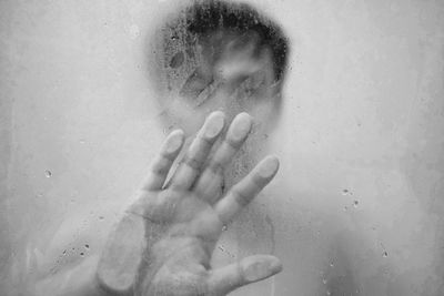 Cropped image of woman with hand on glass