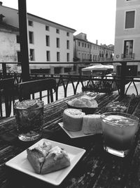 View of drink on table against buildings in city