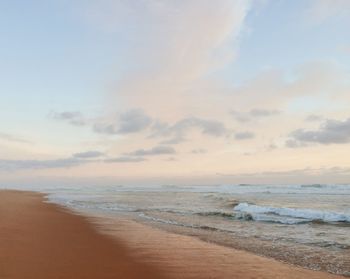 Scenic view of beach against sky during sunset