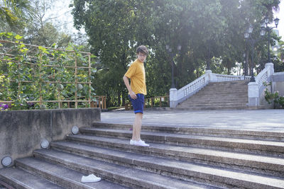 Full length side view of man standing on staircase