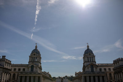 Low angle view of buildings against sky on sunny day