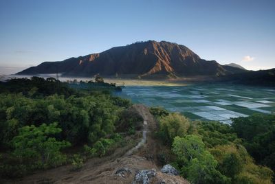 Scenic view of sea and mountains against sky