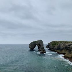 Rocks on sea against sky