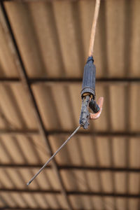 Low angle view of rope hanging on ceiling