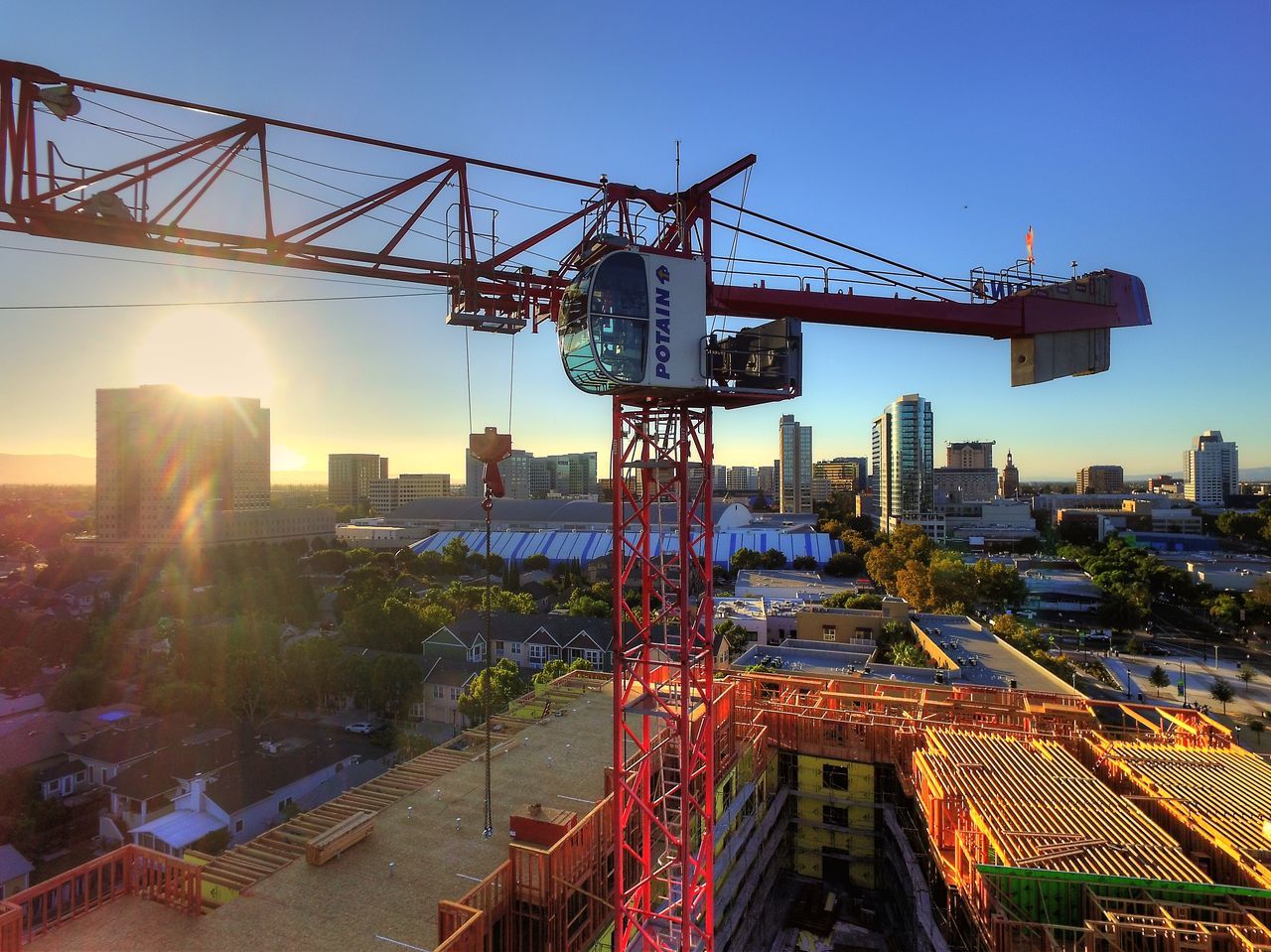 built structure, architecture, construction site, clear sky, building exterior, development, crane - construction machinery, crane, city, industry, sunlight, construction, metal, sunset, construction industry, tall - high, sky, copy space, outdoors, incomplete