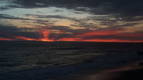 Scenic view of beach against sky during sunset