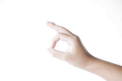 Close-up of human hand against white background