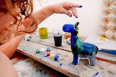 Midsection of woman holding toy