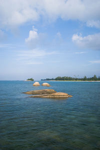 Scenic view of sea against cloudy sky