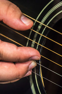 Close-up of hands playing guitar