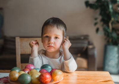 Portrait of boy on table at home