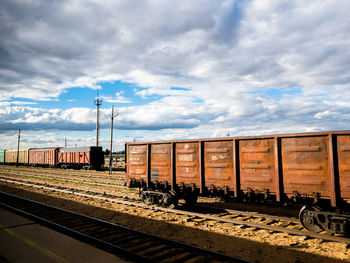Train at railroad tracks against sky