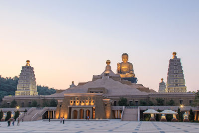 Low angle view of buddha statue at fo guang shan against clear sky