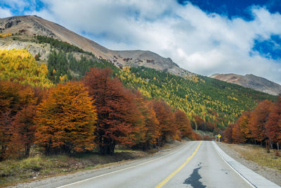 Road amidst mountains against sky