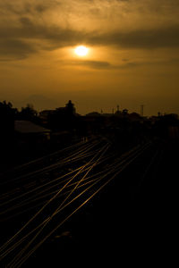 Railroad tracks against sky during sunset