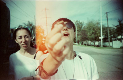 Portrait of smiling man holding camera