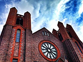 Low angle view of building against cloudy sky