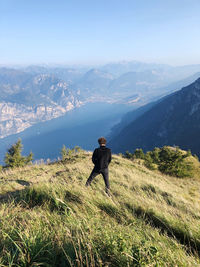 Man standing on mountain against sky