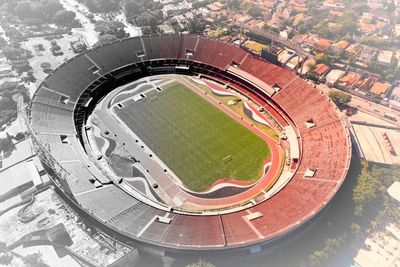 High angle view of soccer field by buildings in city