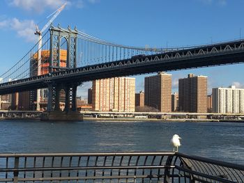 Bridge over river with city in background