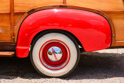 Close-up of red vintage car parked on road