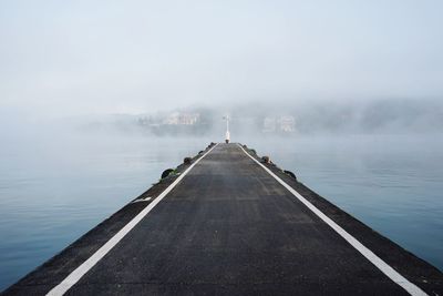 Pier over sea against sky