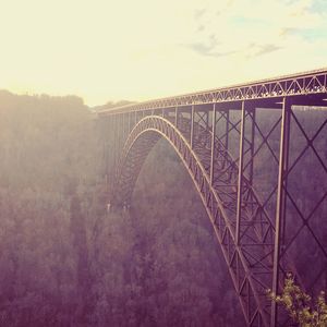 View of bridge in city against sky