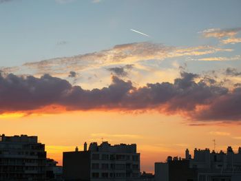 Silhouette buildings against sky during sunset