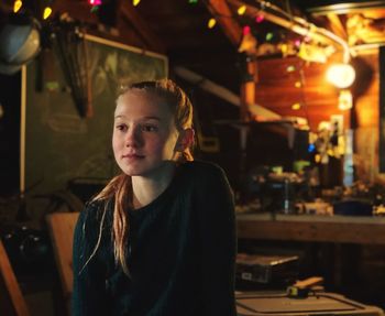 Cute girl sitting in restaurant