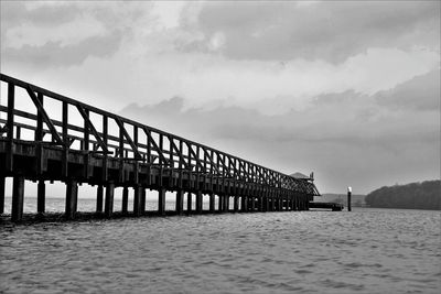 Pier over sea against sky