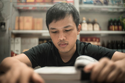Concentrated man reading book at table